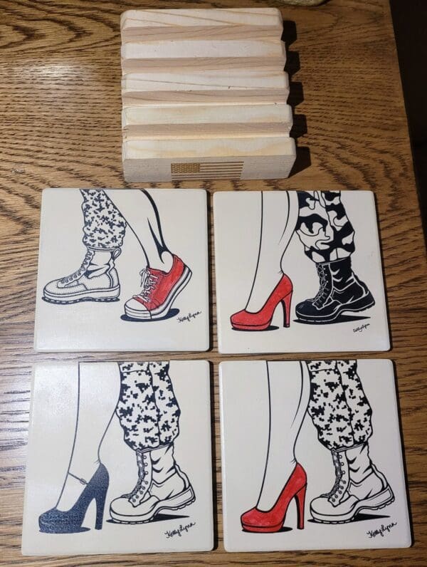 A wooden table with four tile coasters and a box.