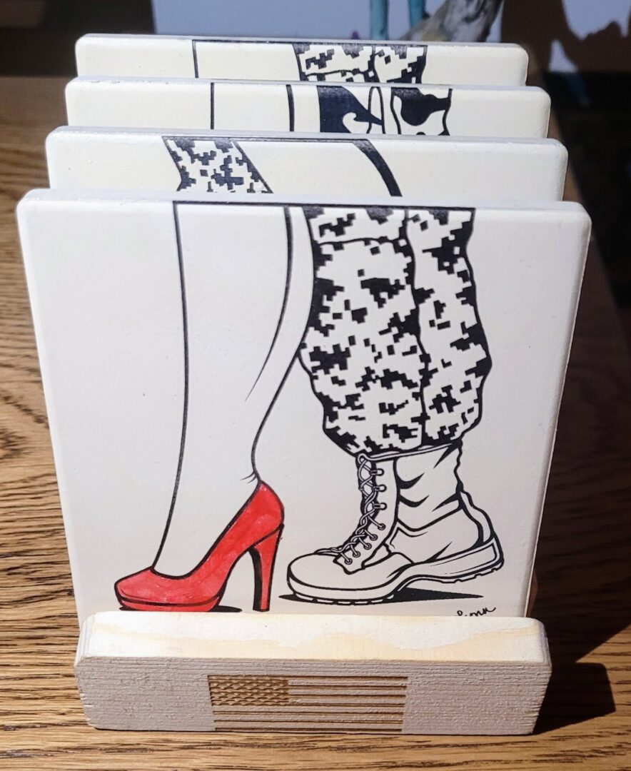 Kelly McCook Series Ceramic Coasters featuring an illustration of mismatched shoes; one red high heel and one lace-up boot, set against a plain background.