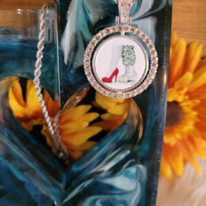 A close up of a necklace with a picture on it