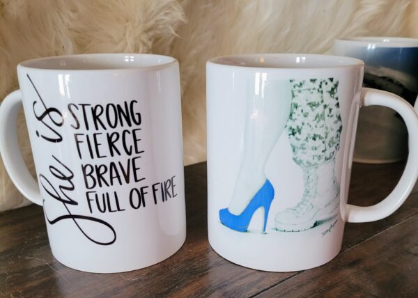 Two coffee mugs with a quote and shoes on them.