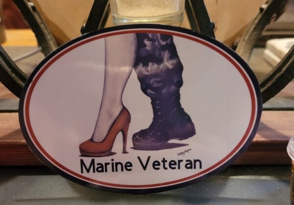 A sign that says marine veteran with two women 's shoes.