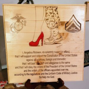 A wooden plaque with the words " welcome to marine corps " and a picture of a woman 's shoe.