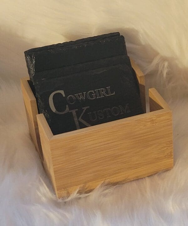 A wooden box holding two soaps on top of it.