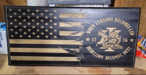 A wooden american flag with the words " when tyranny was no match for rebellion, but war."
