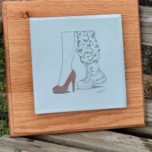 A picture of two pairs of shoes on top of a wooden board.