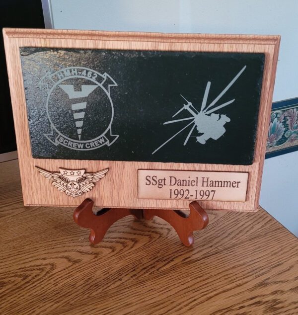 A wooden plaque with an image of a helicopter and the words " sky, daniel hammer 1 9 5 4-1 9 8 7 ".