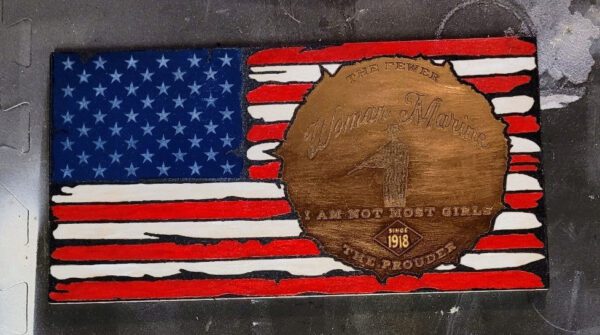 A worn wooden plaque painted with the american flag and a carved emblem featuring the name "eugene monroe," the number 1, and the phrase "i am not most girls and i am proud Custom Flags.