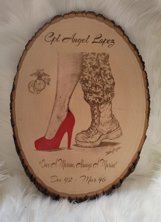 Kelly McCook Live Edge Basswood Plaque commemorating CPL Angel Lopez, featuring etched images of a high heel and a military boot, with a Marine Corps emblem and the inscription "Once a Marine, Always a Marine.