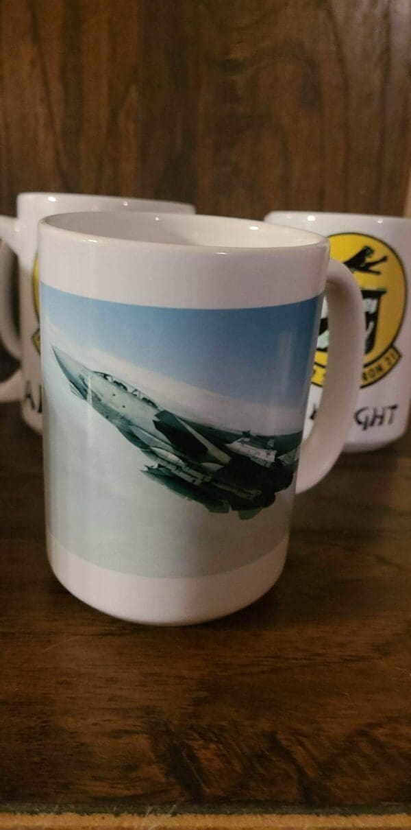 A coffee mug with an image of a fighter jet.