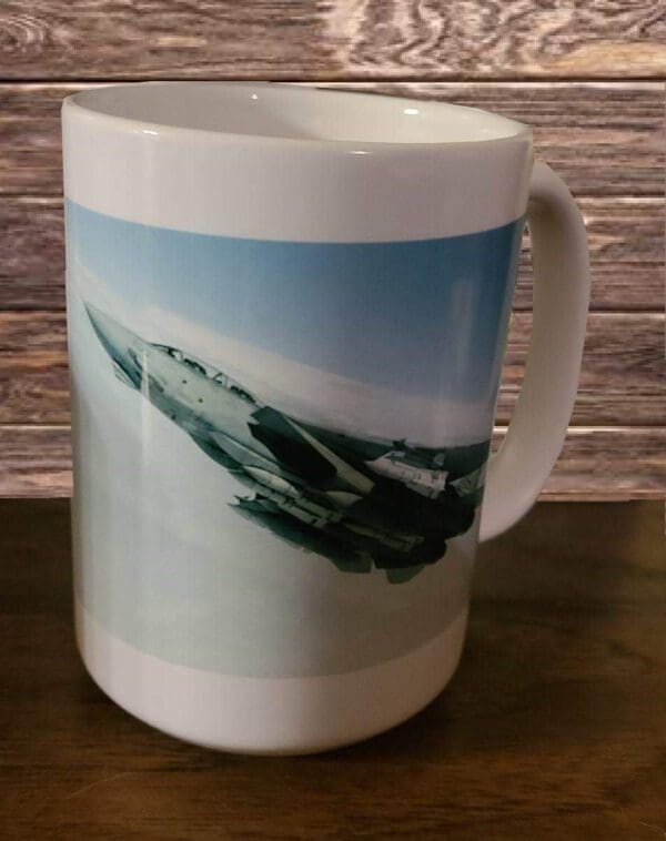 A coffee mug with an image of a jet fighter plane.