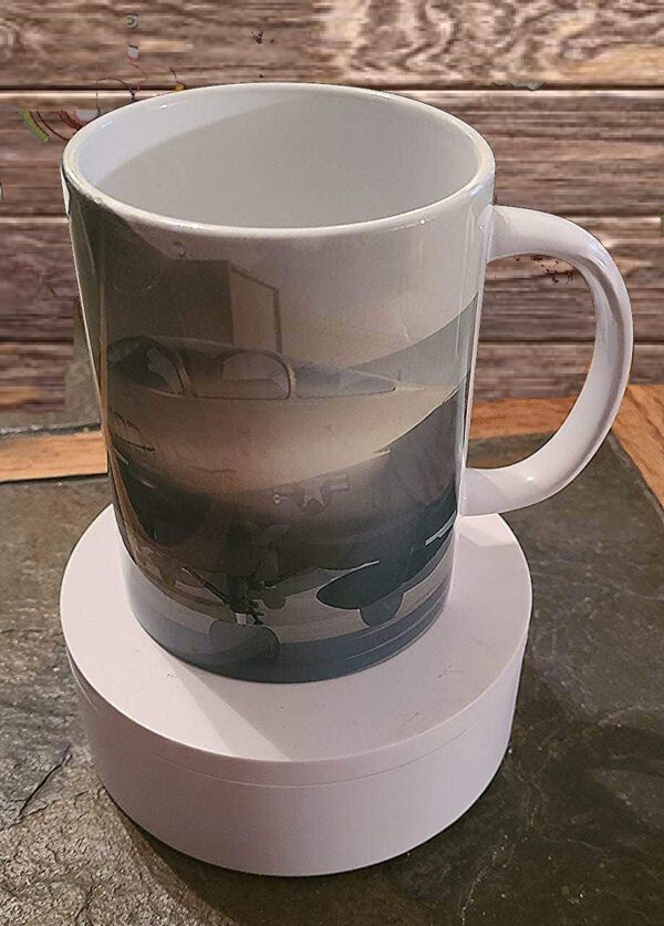 A coffee mug sitting on top of a wooden table.