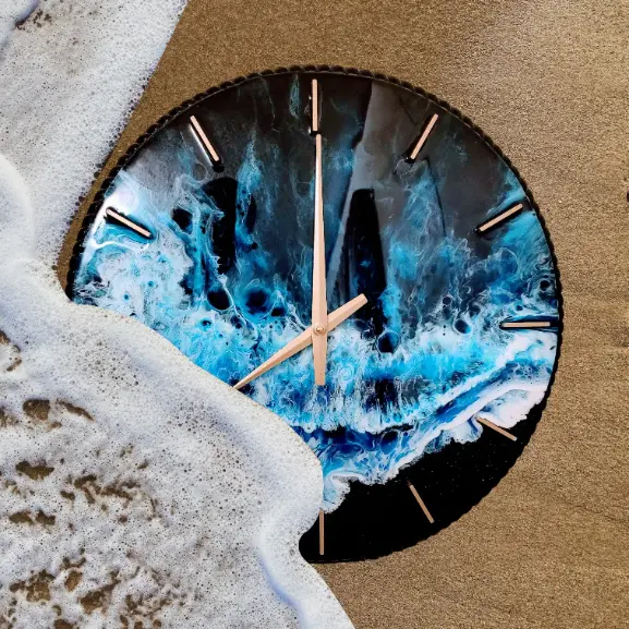 A clock with the image of waves crashing on it.
