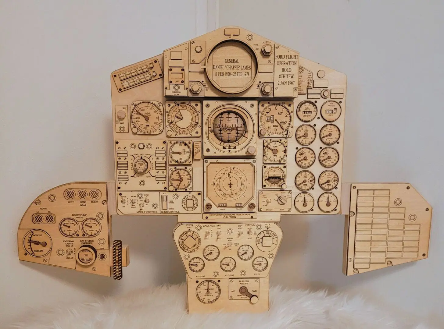 A wooden model of an airplane with many controls.