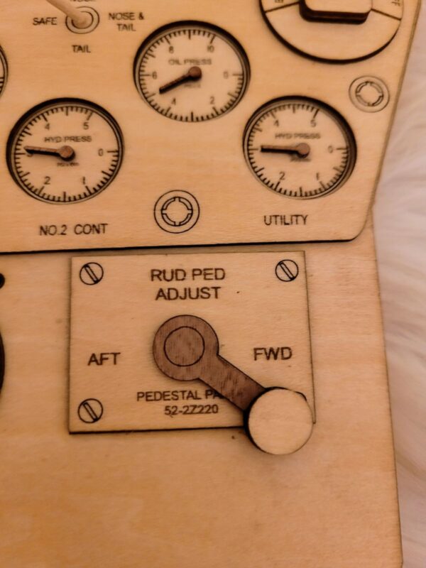 Close-up of a Legend Plaques with various engraved dials and a lever labeled "rud adjust" with markings for "aft" and "fwd.